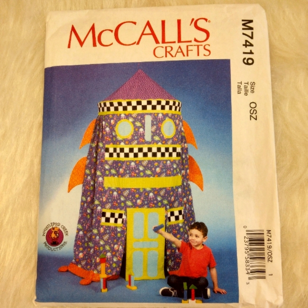 McCall's M7519 Play tent with door flaps, fins, bands, and appliques.